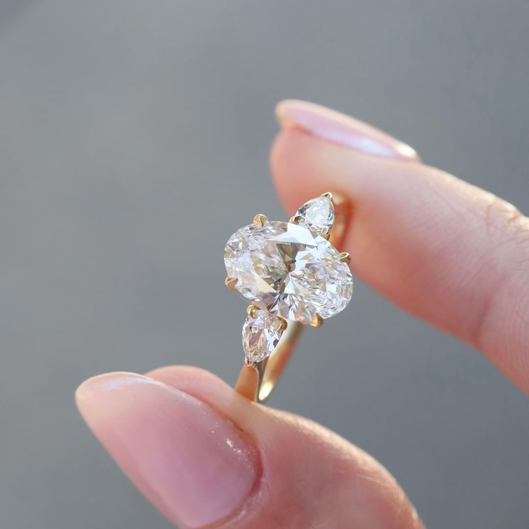 2 CT Oval Cut Lab Grown Engagement Ring in 18K Gold. A vintage-inspired, uniquely bezel-set promise of minimalist wedding bliss.