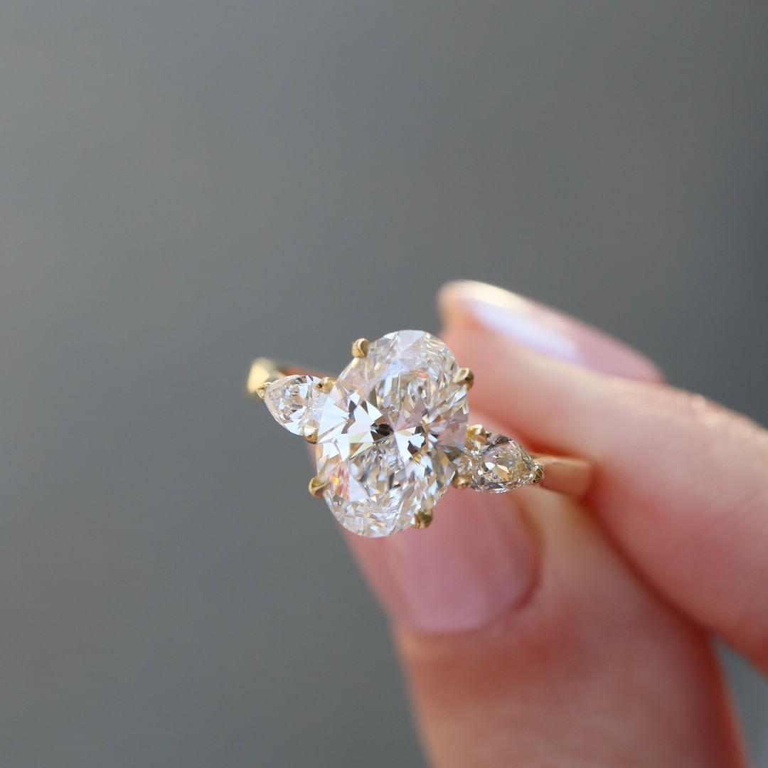 2 CT Oval Cut Lab Grown Engagement Ring in 18K Gold. A vintage-inspired, uniquely bezel-set promise of minimalist wedding bliss.