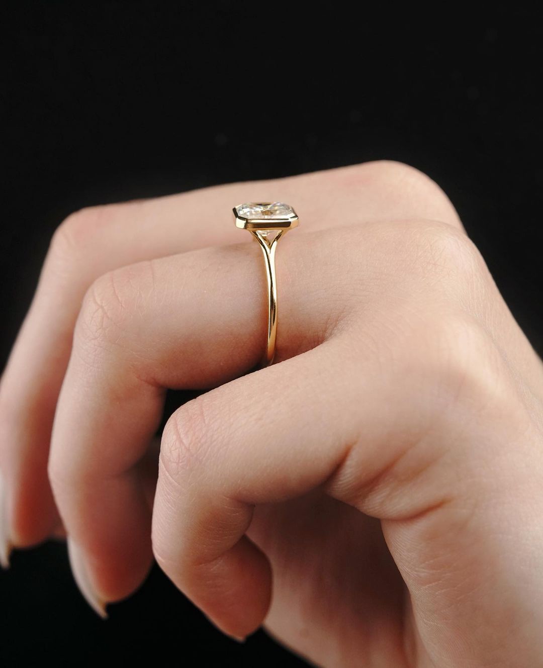 2 CT Emerald Cut Lab Grown Engagement Ring in 18K Gold. A vintage-inspired, uniquely bezel-set promise of minimalist wedding bliss.