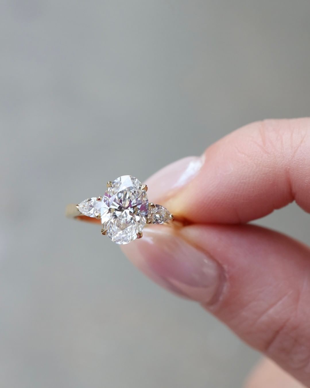 2 CT Oval Cut Lab Grown Engagement Ring in 18K Gold. A vintage-inspired, uniquely bezel-set promise of minimalist wedding bliss.