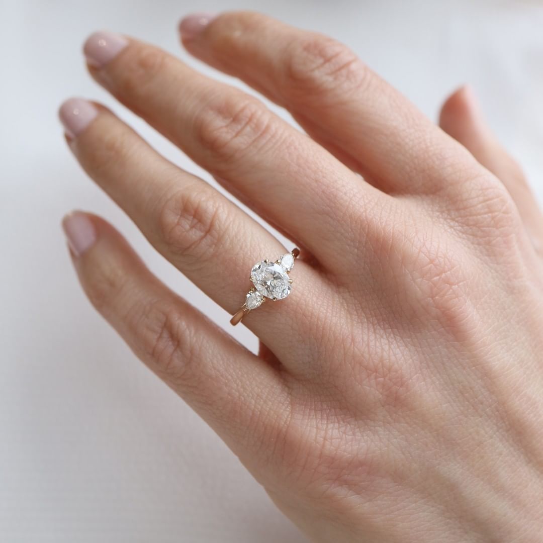 2 CT Oval Cut Lab Grown Engagement Ring in 18K Gold. A vintage-inspired, uniquely bezel-set promise of minimalist wedding bliss.