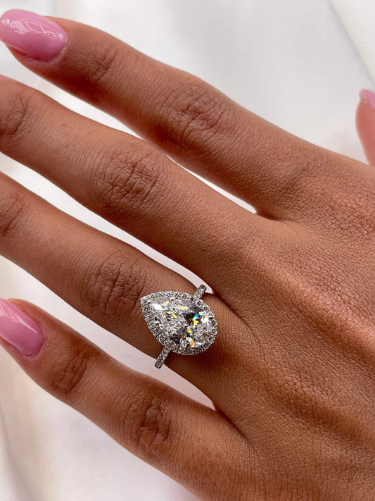 3 CT Pear Cut Lab Grown Diamond Engagement Ring with a sparkling halo and pave setting. The perfect Valentine's Day gift for her.