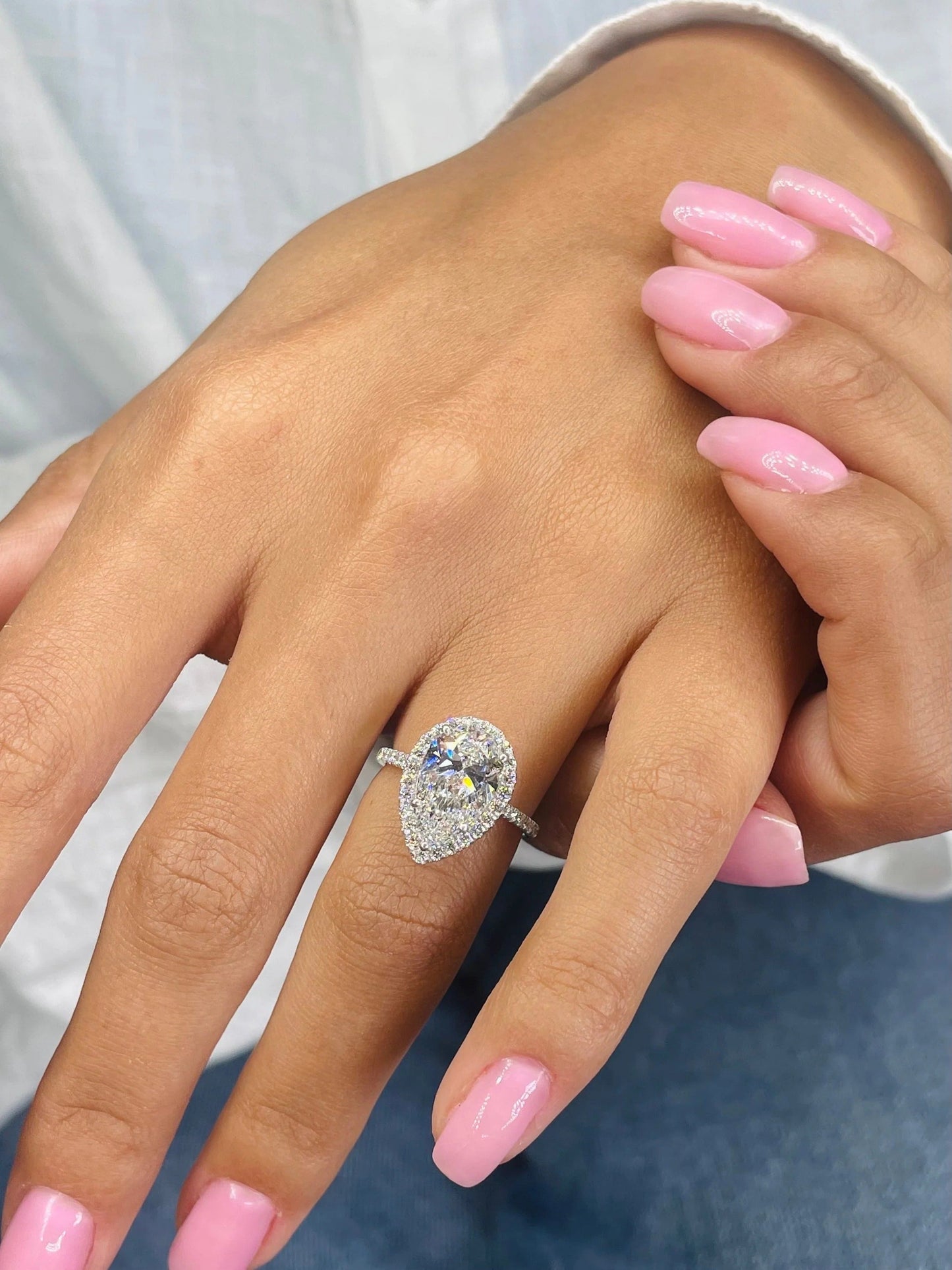 3 CT Pear Cut Lab Grown Diamond Engagement Ring with a sparkling halo and pave setting. The perfect Valentine's Day gift for her.