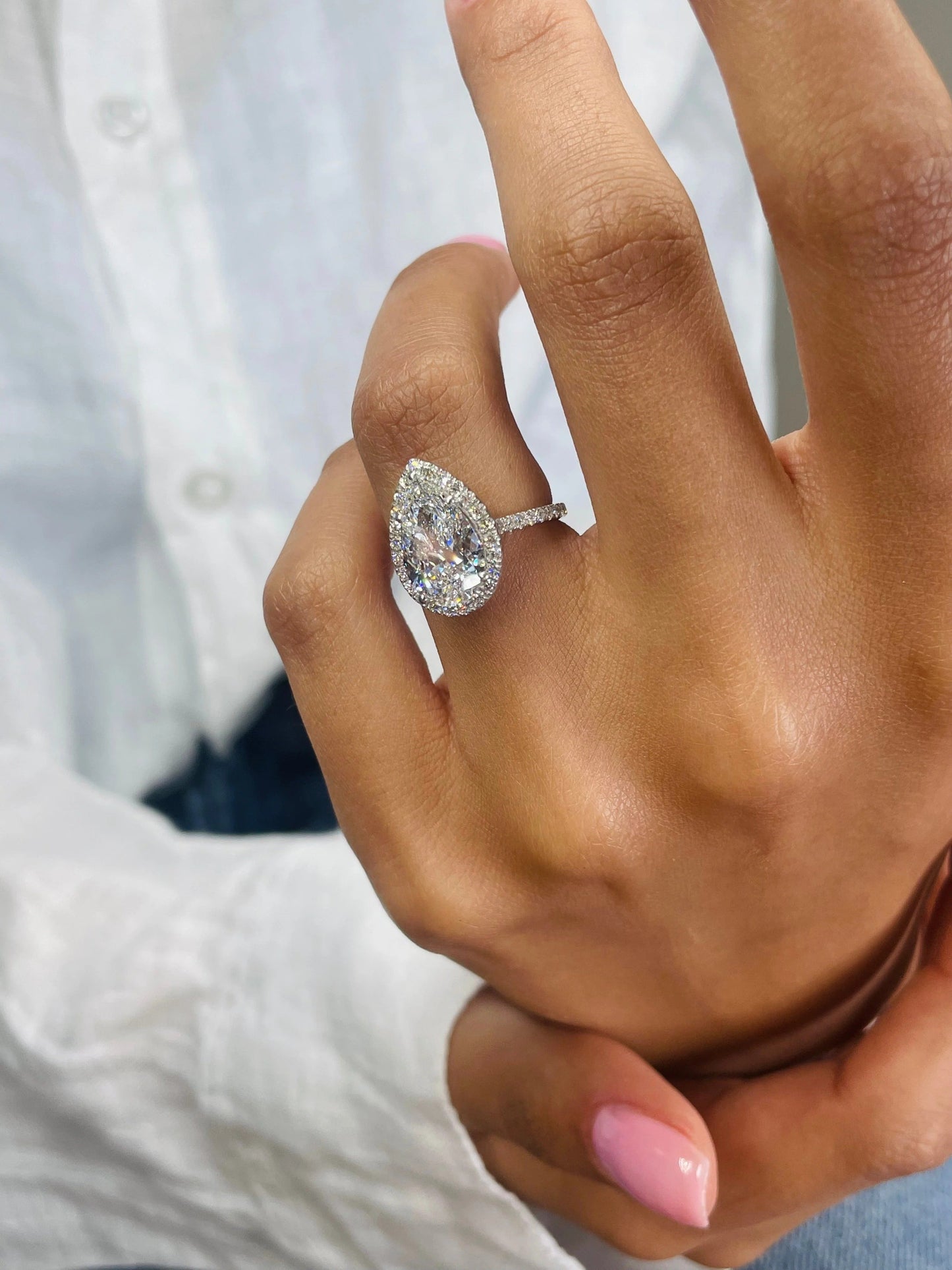3 CT Pear Cut Lab Grown Diamond Engagement Ring with a sparkling halo and pave setting. The perfect Valentine's Day gift for her.